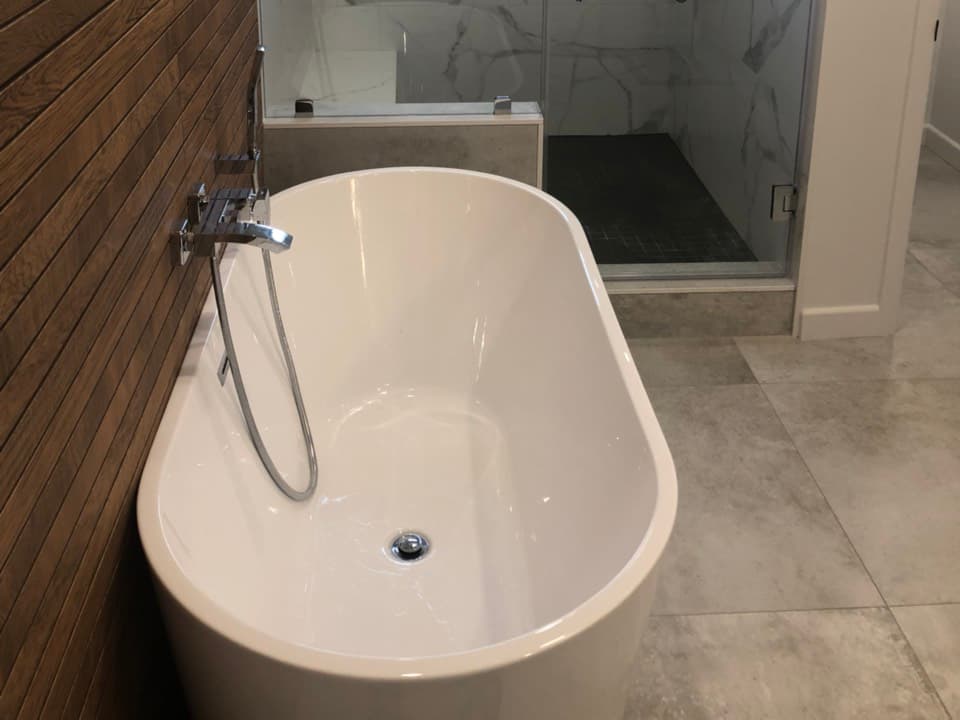 Finished bathroom remodel in Los Angeles with plumbing by A+ Electric & Plumbing: freestanding tub and glass shower.