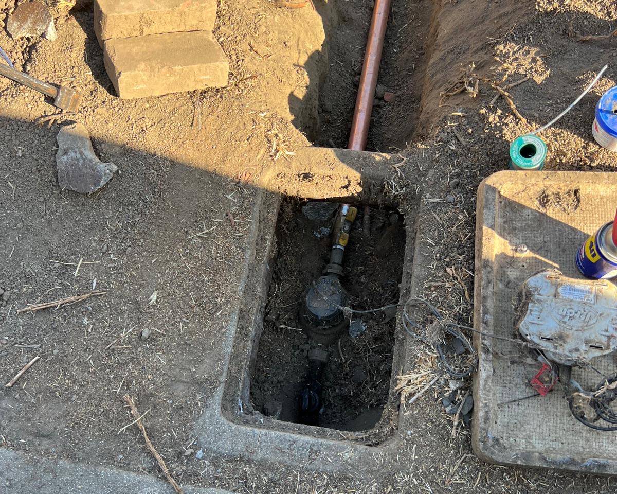 New copper water main and whole-house repipe by A+ Electric & Plumbing, a licensed plumber in Los Angeles: copper line run through an open trench to the meter.