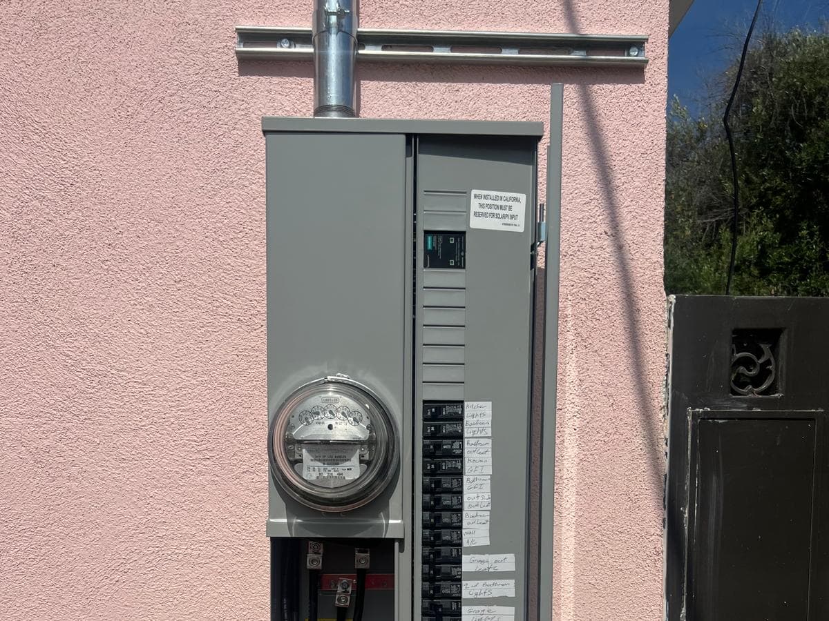 Open electrical panel with labeled breakers during a repair visit by A+ Electric & Plumbing in Los Angeles.